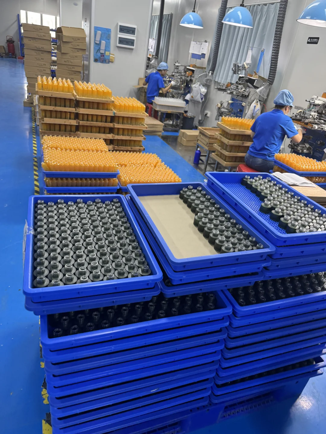 Glass bottles in trays beside decoration workstations