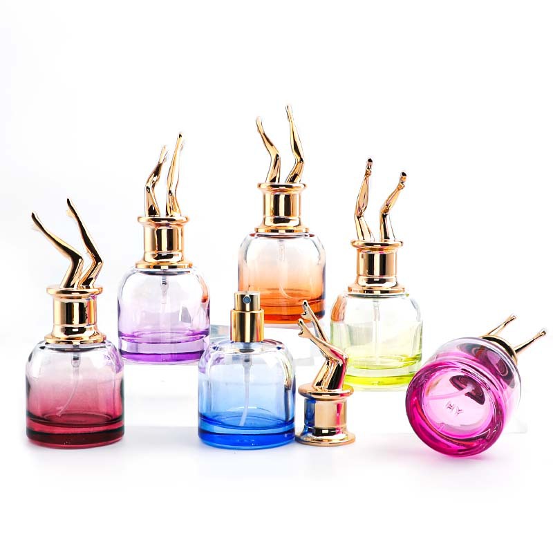 Colored perfume bottles with sculptural gold-colored caps